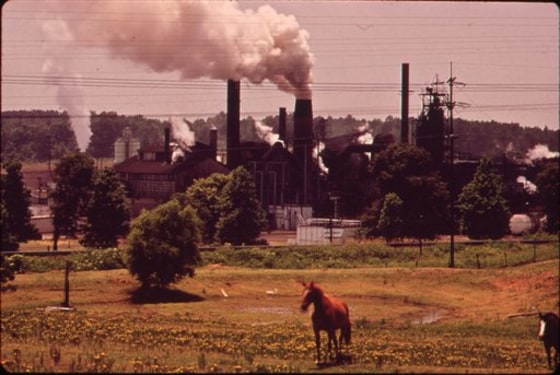 In this June 1973 photo provided by the U.S. National Archives, a chemical plant adjoins a pasture in Marshall, Texas. The photo is part of Documerica, an EPA project during the 1970s in which the agency hired dozens of freelance photographers to capture thousands of images related to the environment and everyday life in America. Modeled after Documerica, the agency has embarked on a massive effort to collect photographs from across the United States and around the world over the next year.